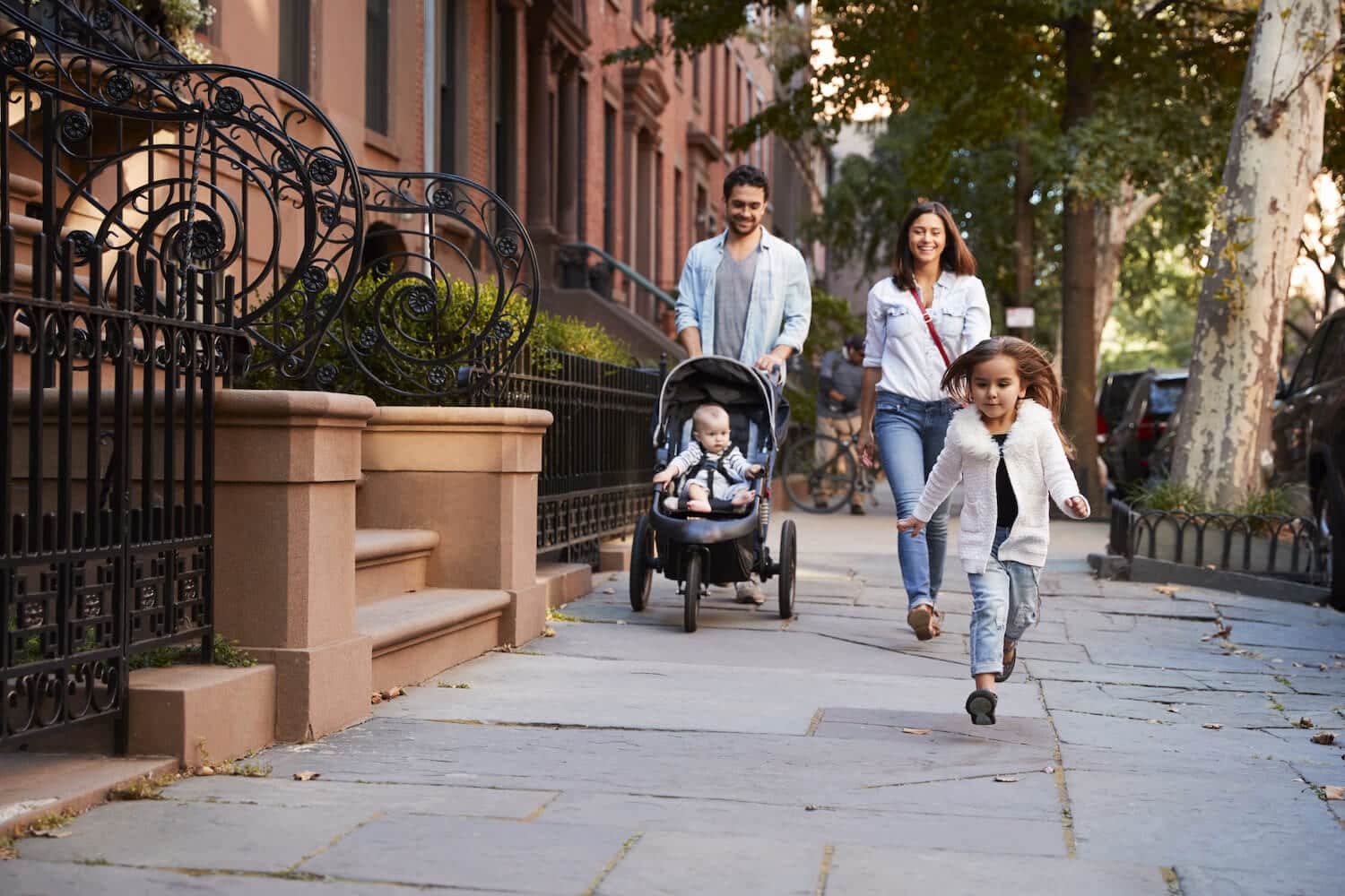 Family taking a walk down the street Adobestock 186708775