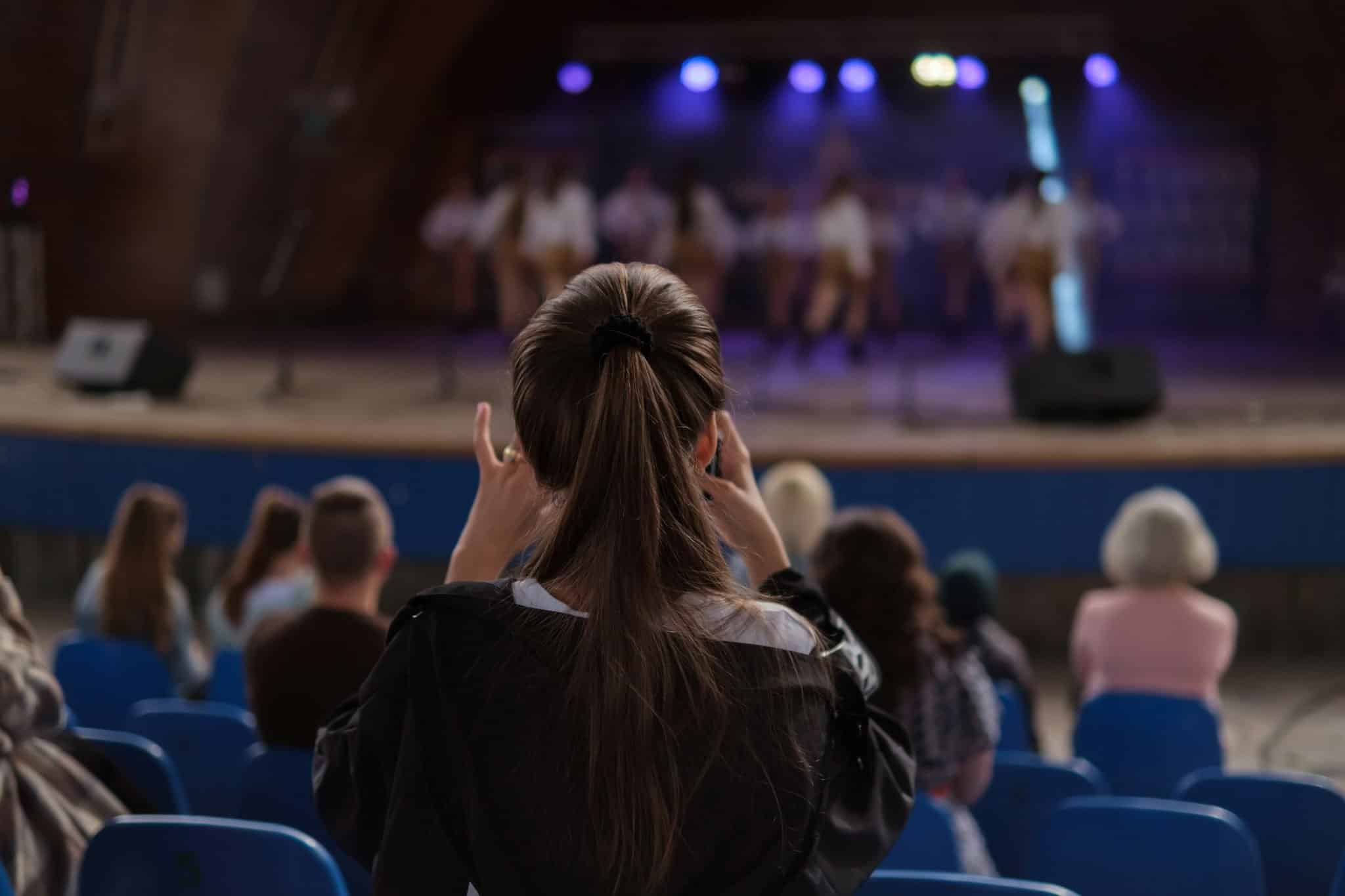 Girl recording stage performance Girl recording stage performance