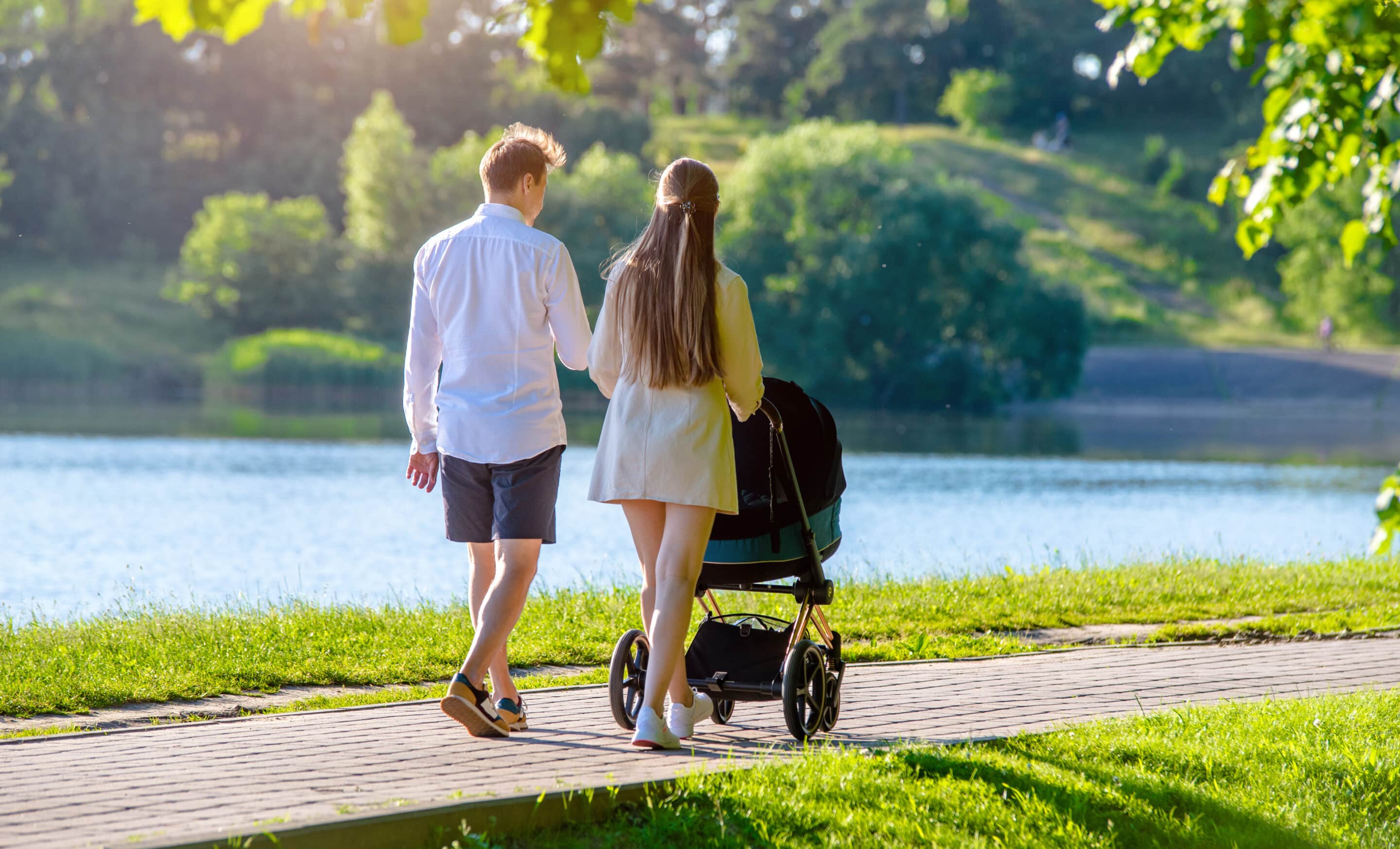 Happy couple takes a stroll with baby